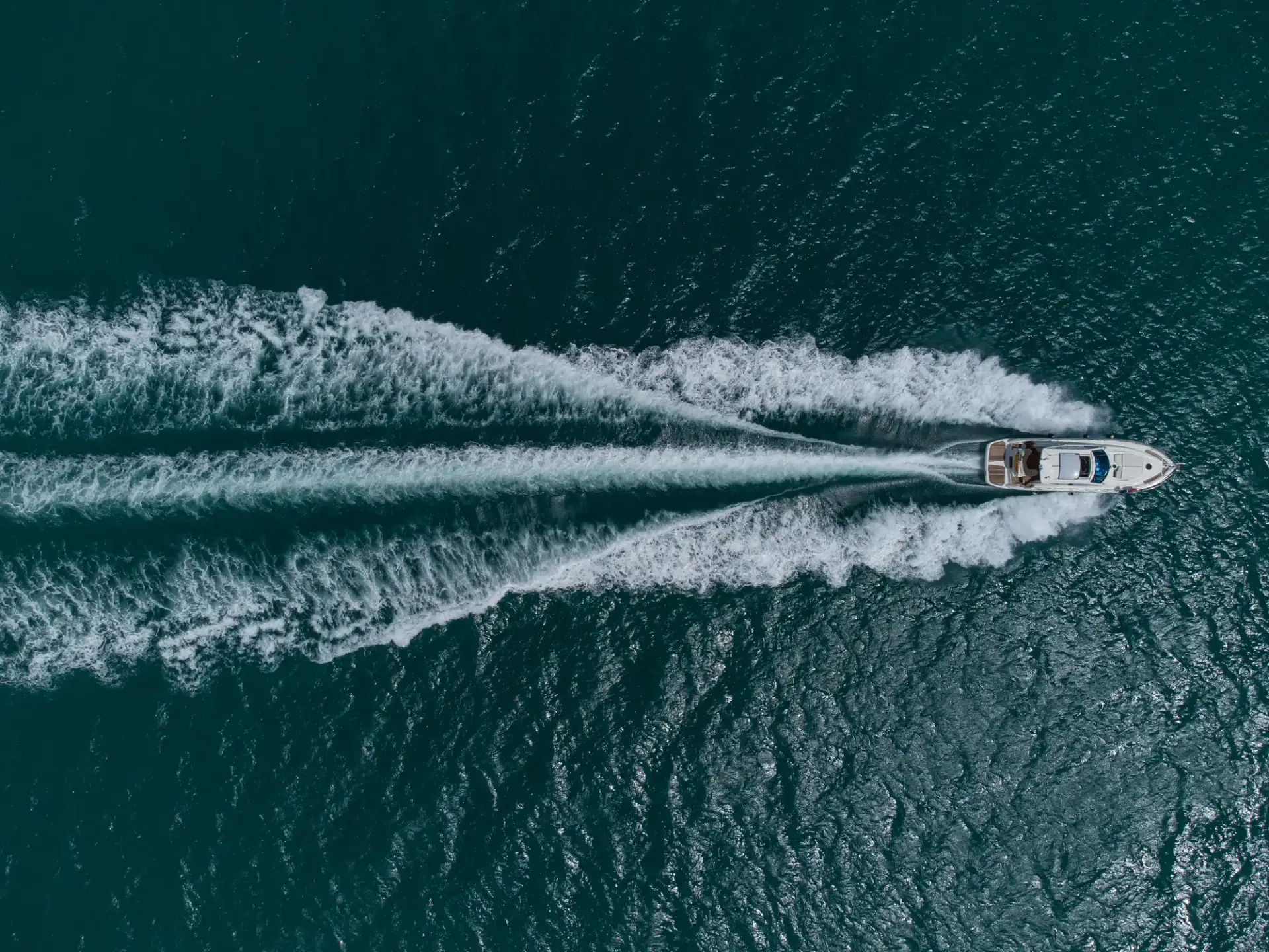 aerial-top-down-view-of-speed-motor-boat-on-open-s-2026-03-20-00-52-16-utc